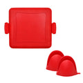 Red silicone baking tray with matching oven gloves set on kitchen counter