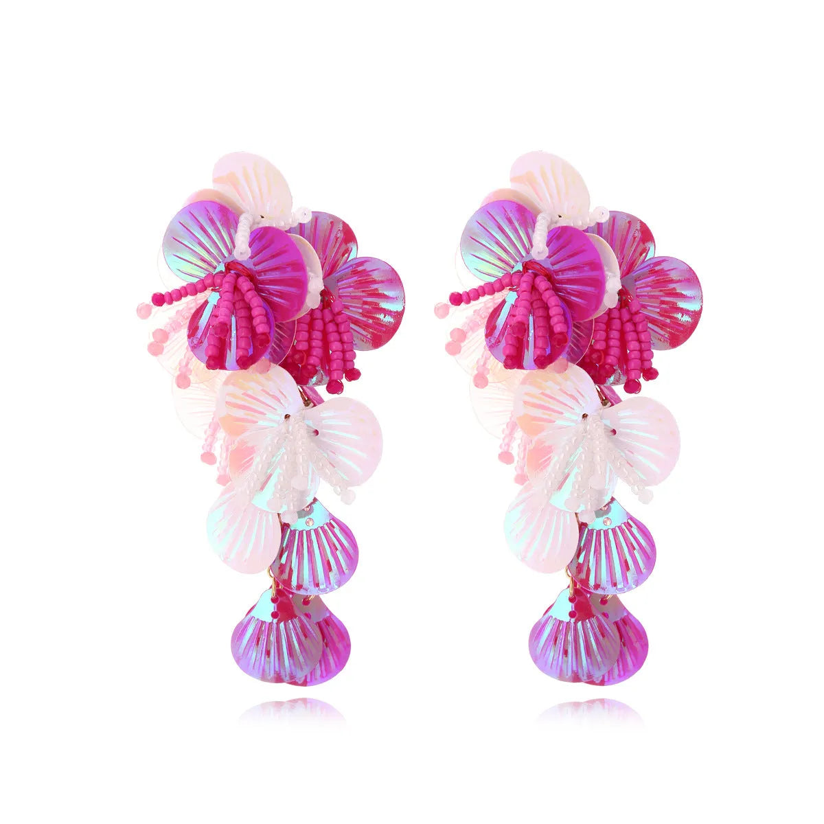 Close-up of handmade purple and green bead flower earrings with leaf details on a white background.