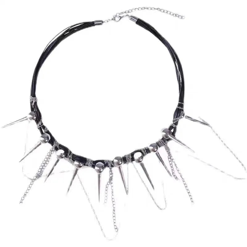 Leather necklace with winding round beads, rivet details, and a long tassel pendant in a metallic colour.
