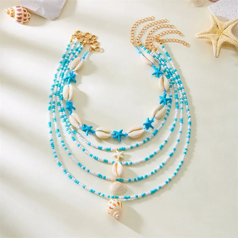Five women's necklaces with shell and conch bead pendants on adjustable electroplated alloy chains
