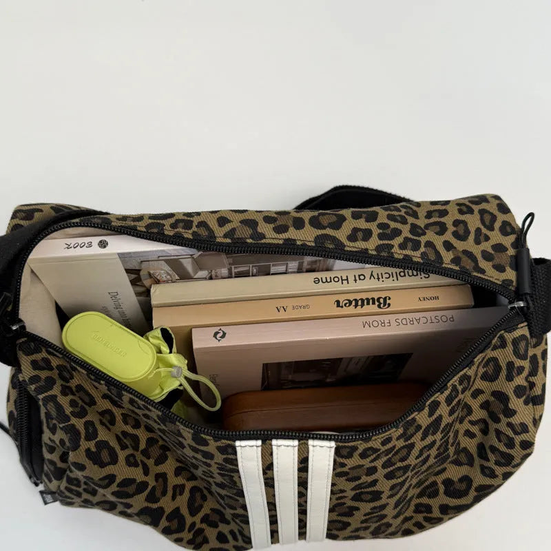 Leopard print cross-body messenger bag with shoulder strap and stitching details