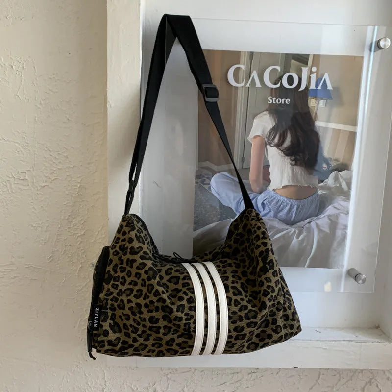 Leopard print cross-body messenger bag with shoulder strap and stitching details
