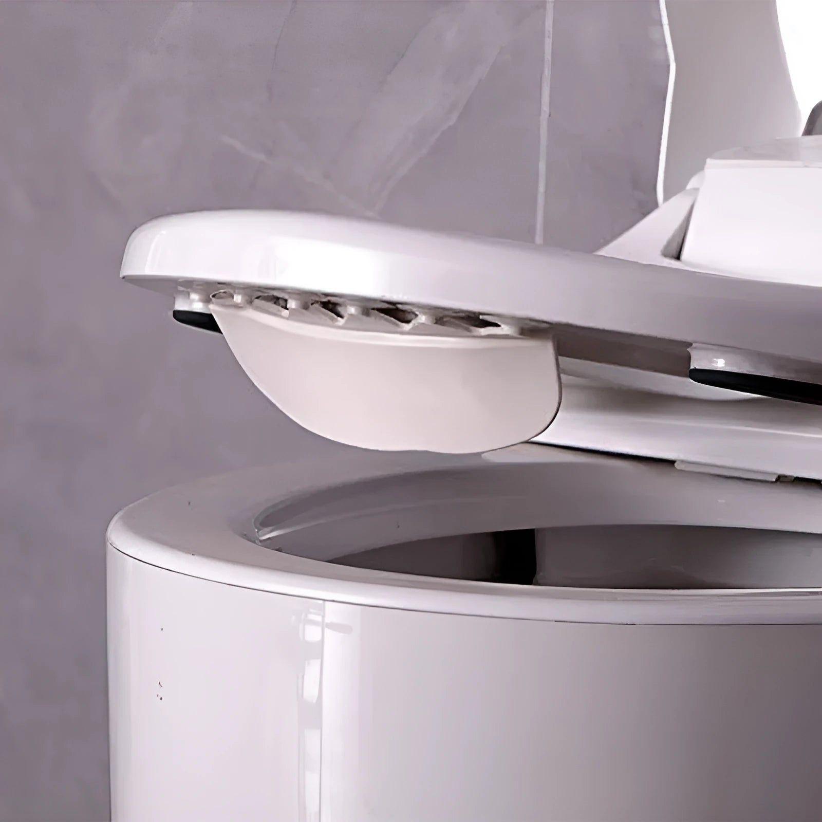 White PVC urine blocking splash guard for toilet training, shown on a toilet seat.