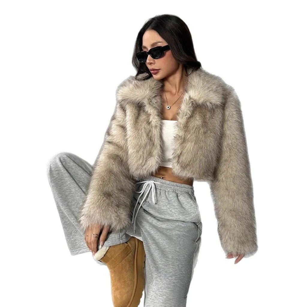 Women's short length artificial fur coat with a fur collar in a black tip on black background colour.