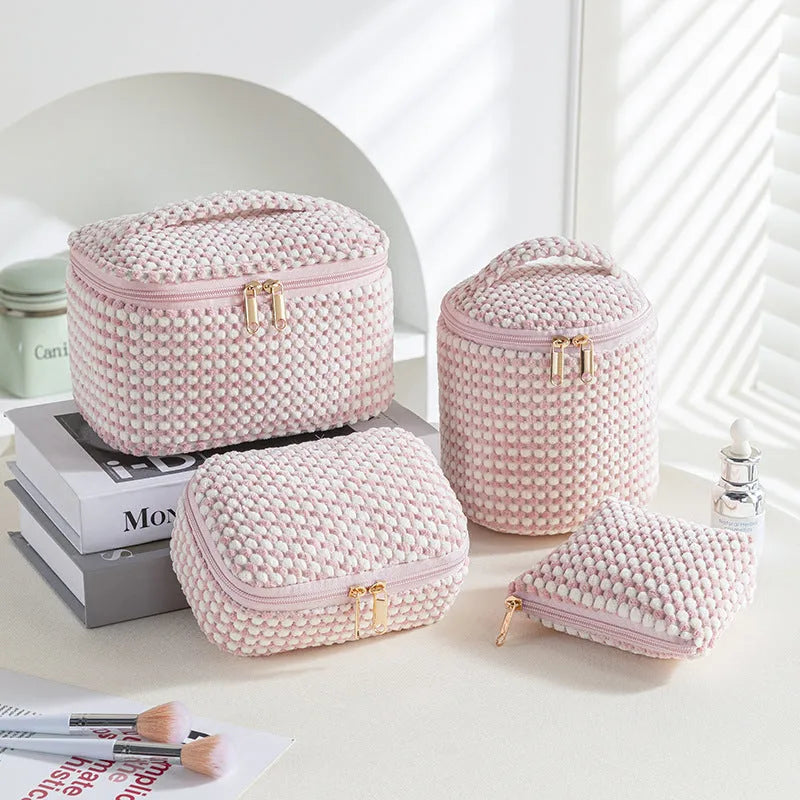Four cube-style flannelette makeup bags in coordinating colours showing portable cosmetic organiser set