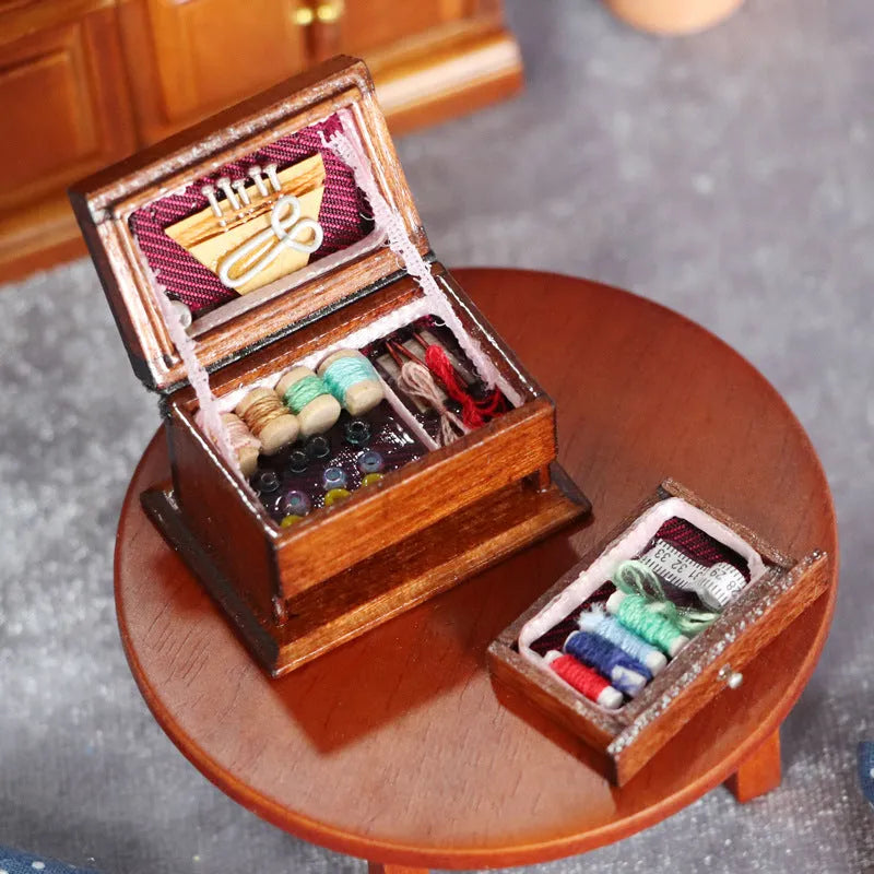 Small vintage sewing machine miniature ornament in a birch wood box with accessories.
