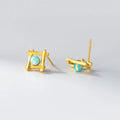 Geometric cross-shaped silver stud earrings with angular design, available in gold or silver finish.