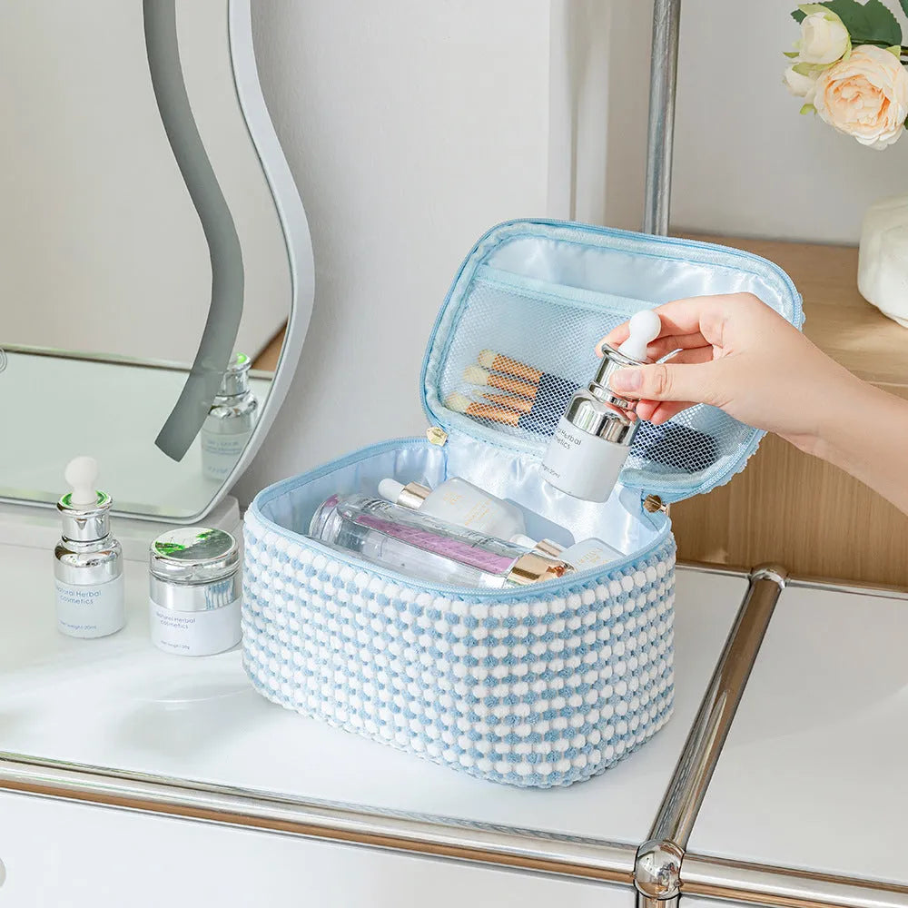 Four cube-style flannelette makeup bags in coordinating colours showing portable cosmetic organiser set