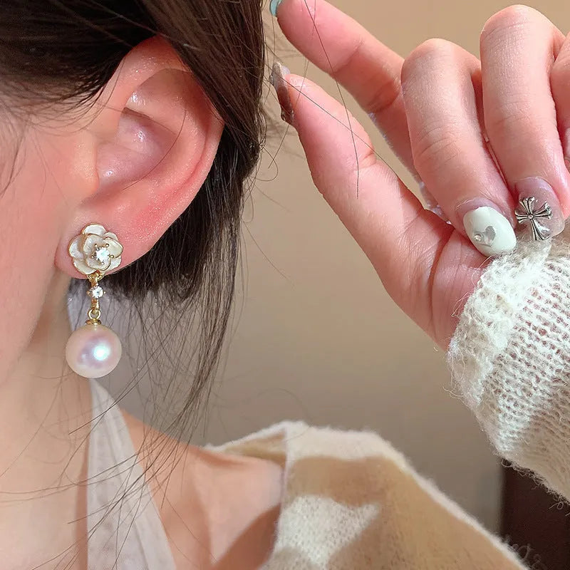 A pair of camellia flower-shaped stud earrings for women in alloy.