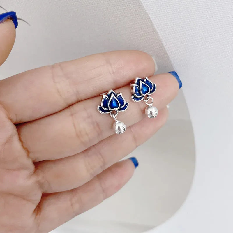 Blue lotus ear studs with seedpod tassel design and retro artistic style
