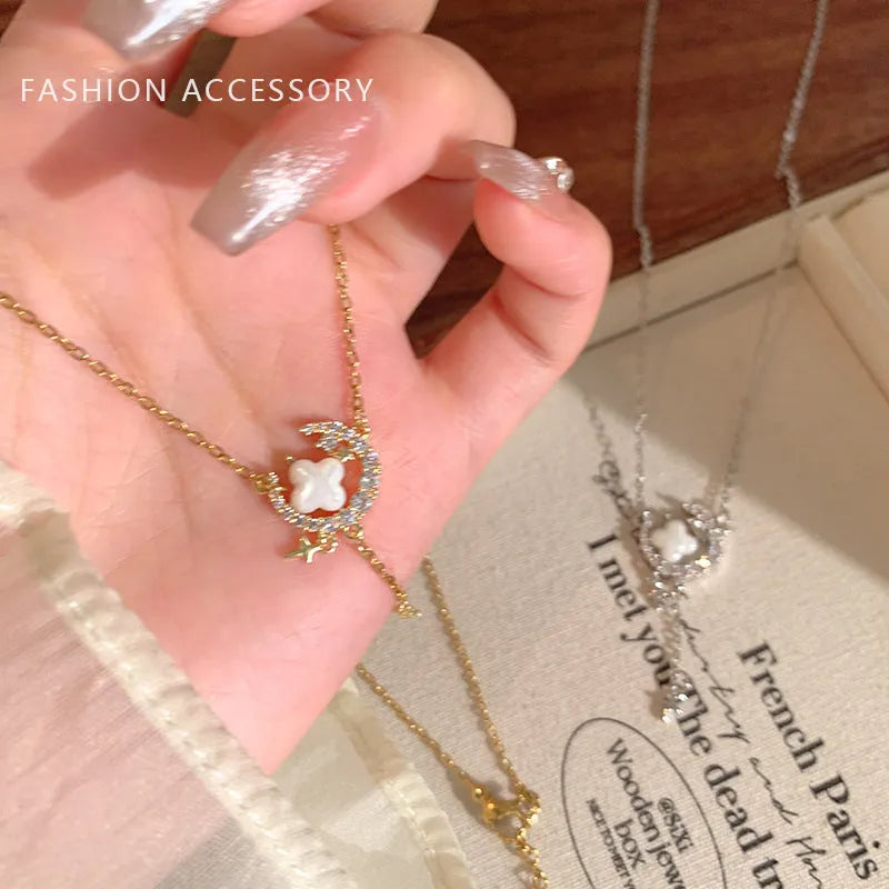 Gold celestial necklace with star and moon pendant on delicate clavicle chain