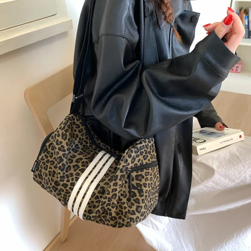 Leopard print cross-body messenger bag with shoulder strap and stitching details