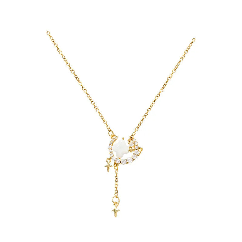 Gold celestial necklace with star and moon pendant on delicate clavicle chain
