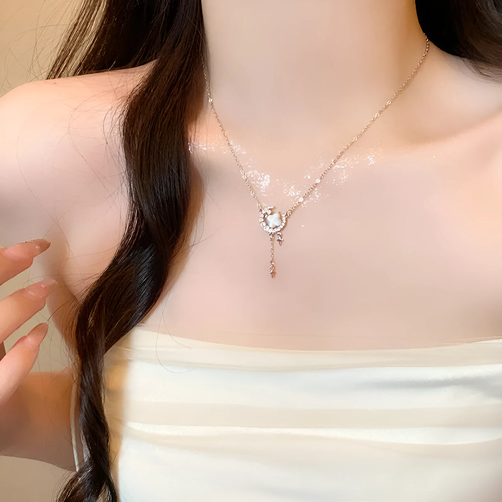 Gold celestial necklace with star and moon pendant on delicate clavicle chain
