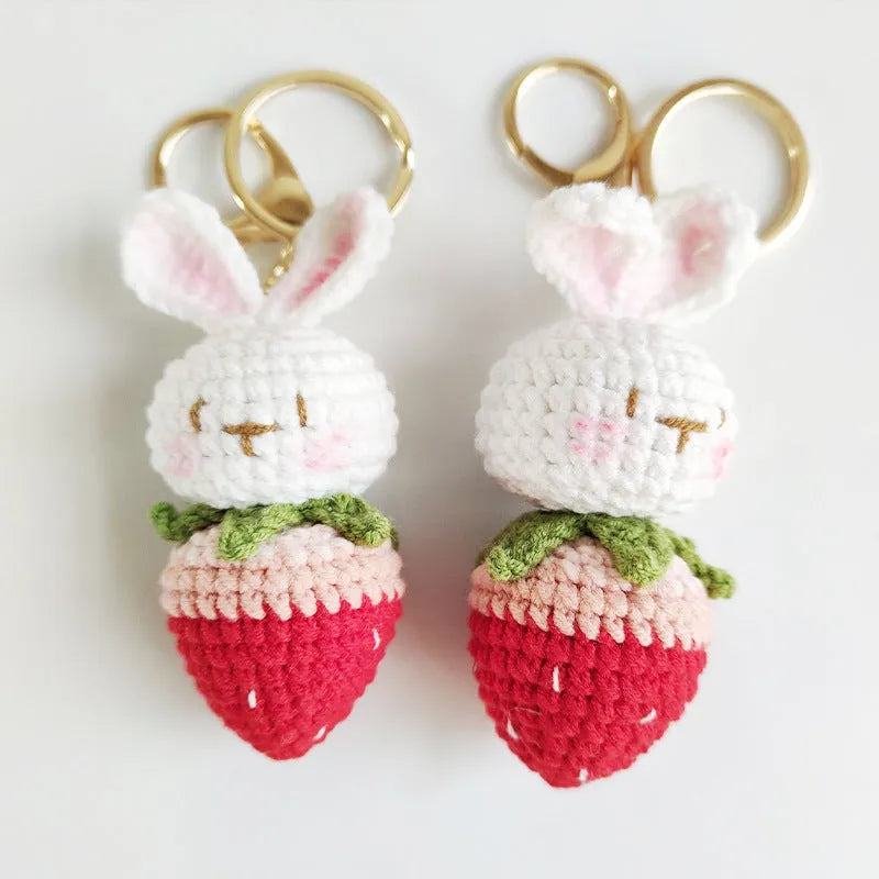White hand-woven rabbit strawberry wire pendant with key on a white background