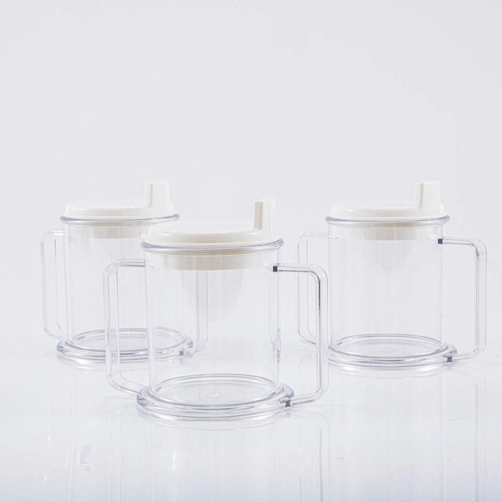 Transparent plastic drinking cup with a black spill-proof lid on a white background