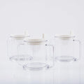 Transparent plastic drinking cup with a black spill-proof lid on a white background