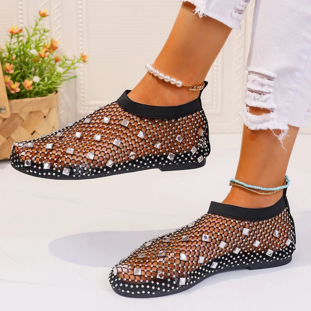 Women's flat mesh sandals with colourful rhinestone decoration on the upper and a round toe.