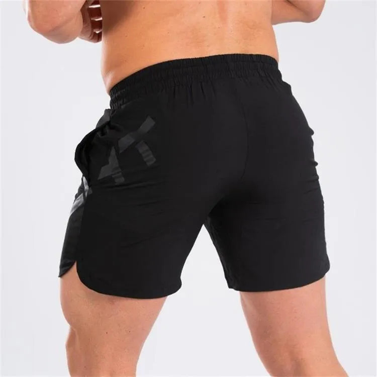 Men's elastic knee-length training shorts in quick-drying chemical blend fabric shown in black colour