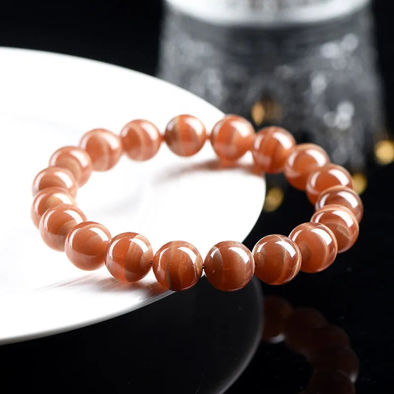 Natural old mine rhodochrosite round bead bracelet with ruyi design element.