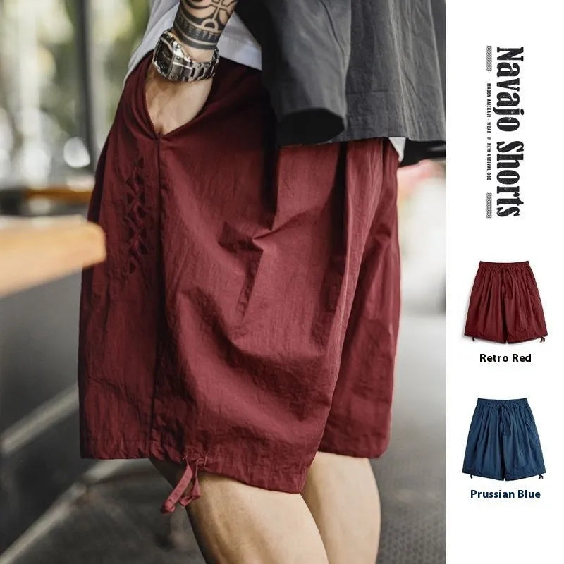 Men's loose fit beach shorts with embroidered design in Prussian Blue colour