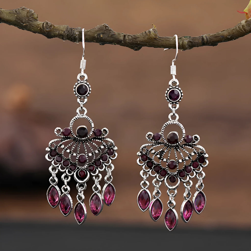 Long purple fringe drop earrings with retro crystal design on a white background.