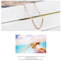Women's necklace with heart-shaped pink crystal pendant on rose gold cross chain