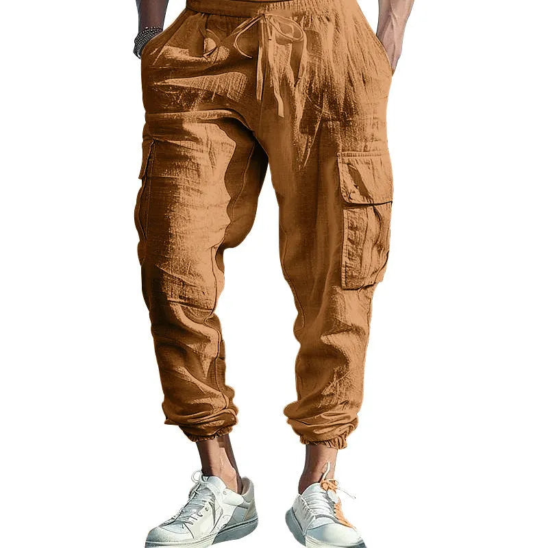 Man wearing khaki linen casual trousers with ankle-tied cuffs and multiple pockets.