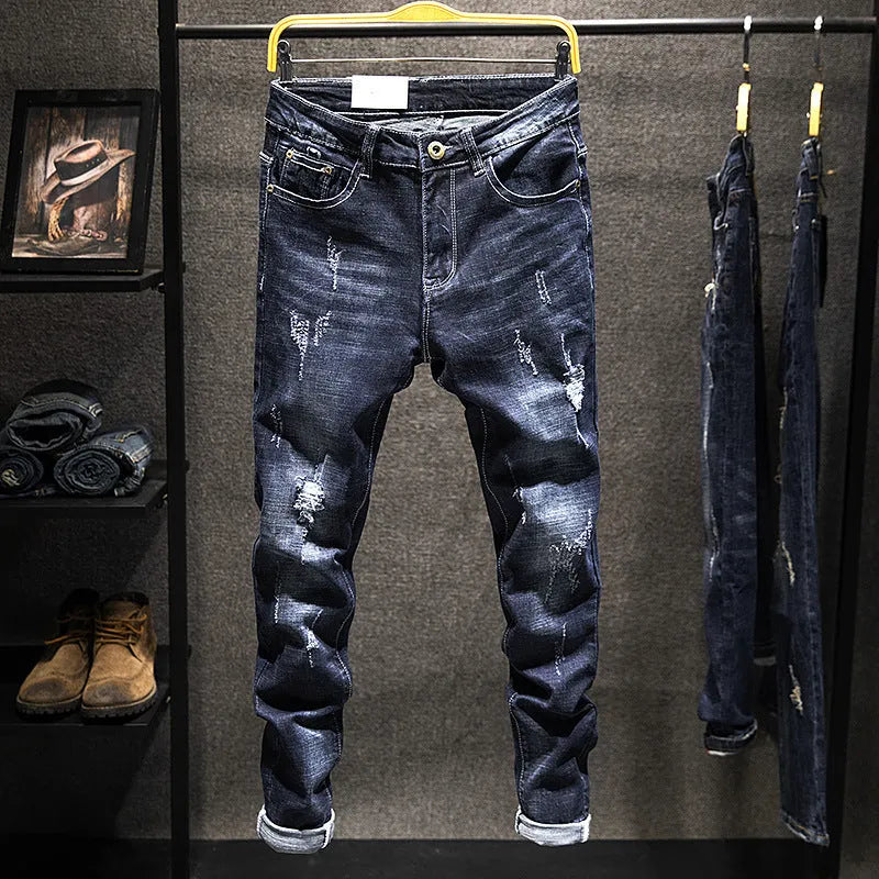 Men's slim-fit skinny jeans in dark blue cotton denim fabric on a hanger.
