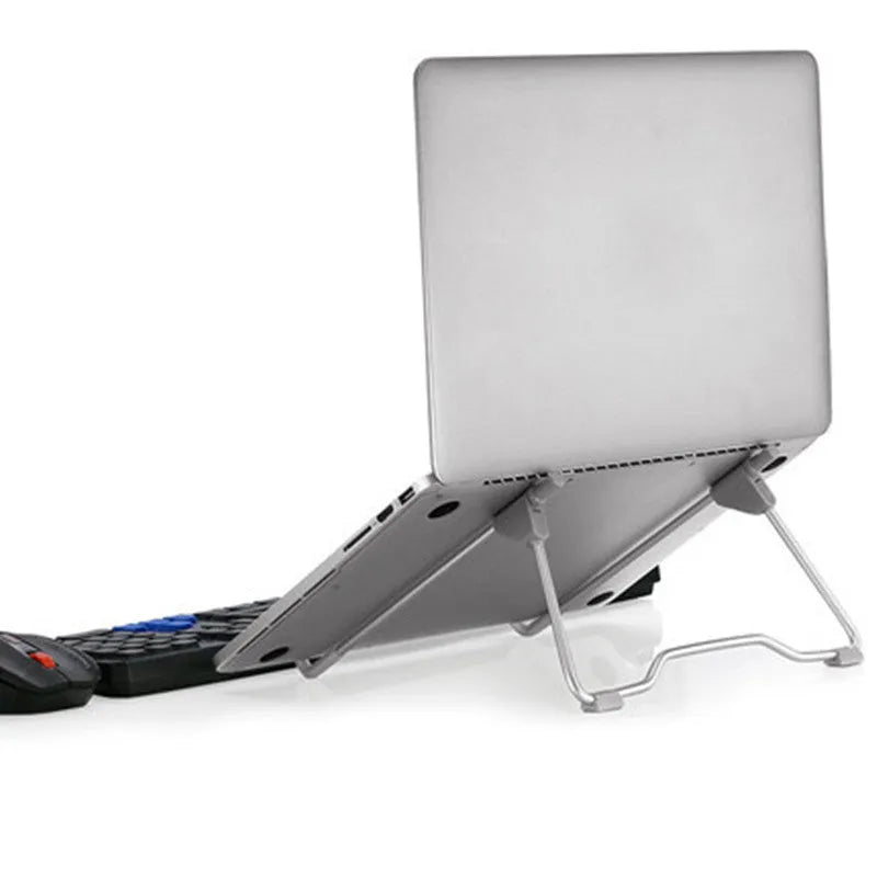 Grey aluminium alloy and plastic foldable stand holding a mobile phone and a laptop.