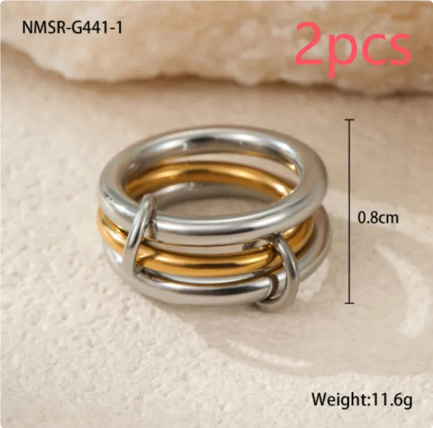 Stacked gold plated stainless steel rings with an exaggerated wide band design, shown in a free size.