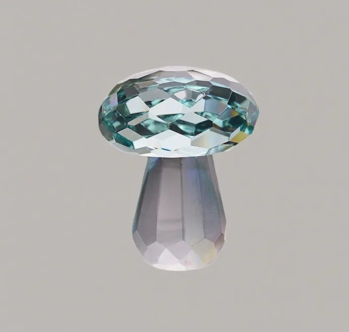 Colourful geometric crystal mushroom decoration in transparent, green, red, or yellow on a white background.