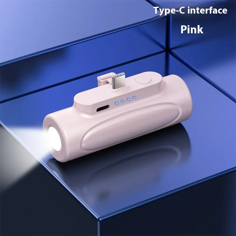 Black and pink portable power bank with integrated LED flashlight, showing Type-C and Apple port options.