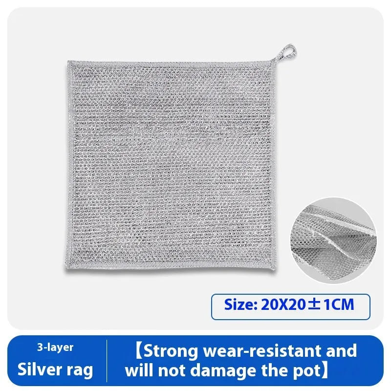 Silver microfiber cleaning rag with a built-in steel wire scrubber ball on a kitchen counter.