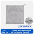 Silver microfiber cleaning rag with a built-in steel wire scrubber ball on a kitchen counter.
