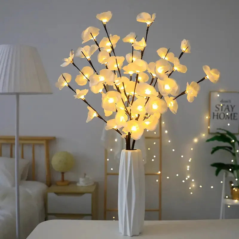Pink LED phalaenopsis orchid branch decorative light, 65cm long, with warm white illumination on battery power.