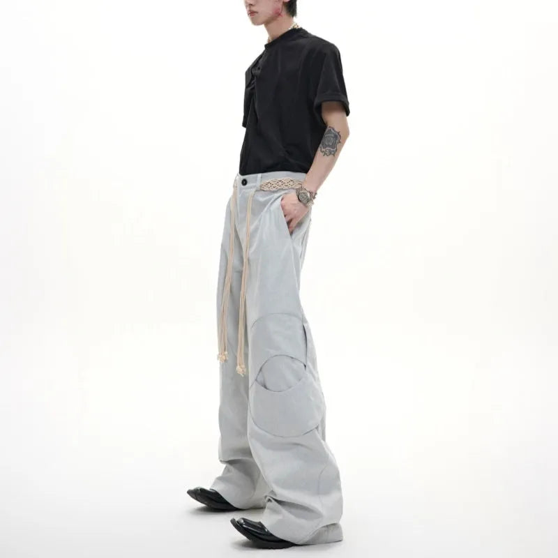 Men's dark blue straight-leg jeans with 3D cutting, belt stitching, and decorative pocket details