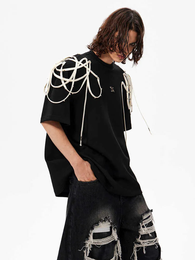 Black loose fit T-shirt with padded shoulder detail and rivet ribbon accent.