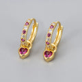 Women's gold tone earrings with a heart-shaped clip and a pink zircon drop pendant.