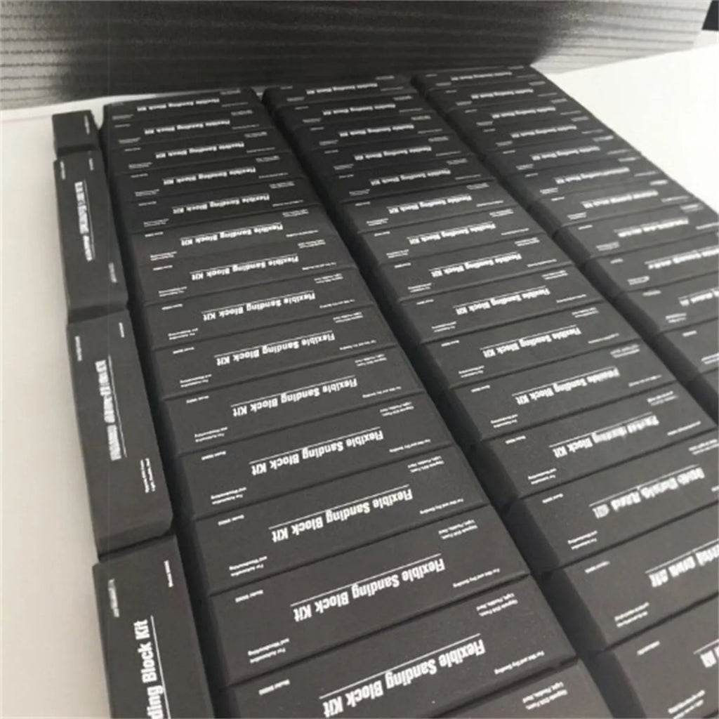 Seven black frosted building blocks with metal construction arranged as a set