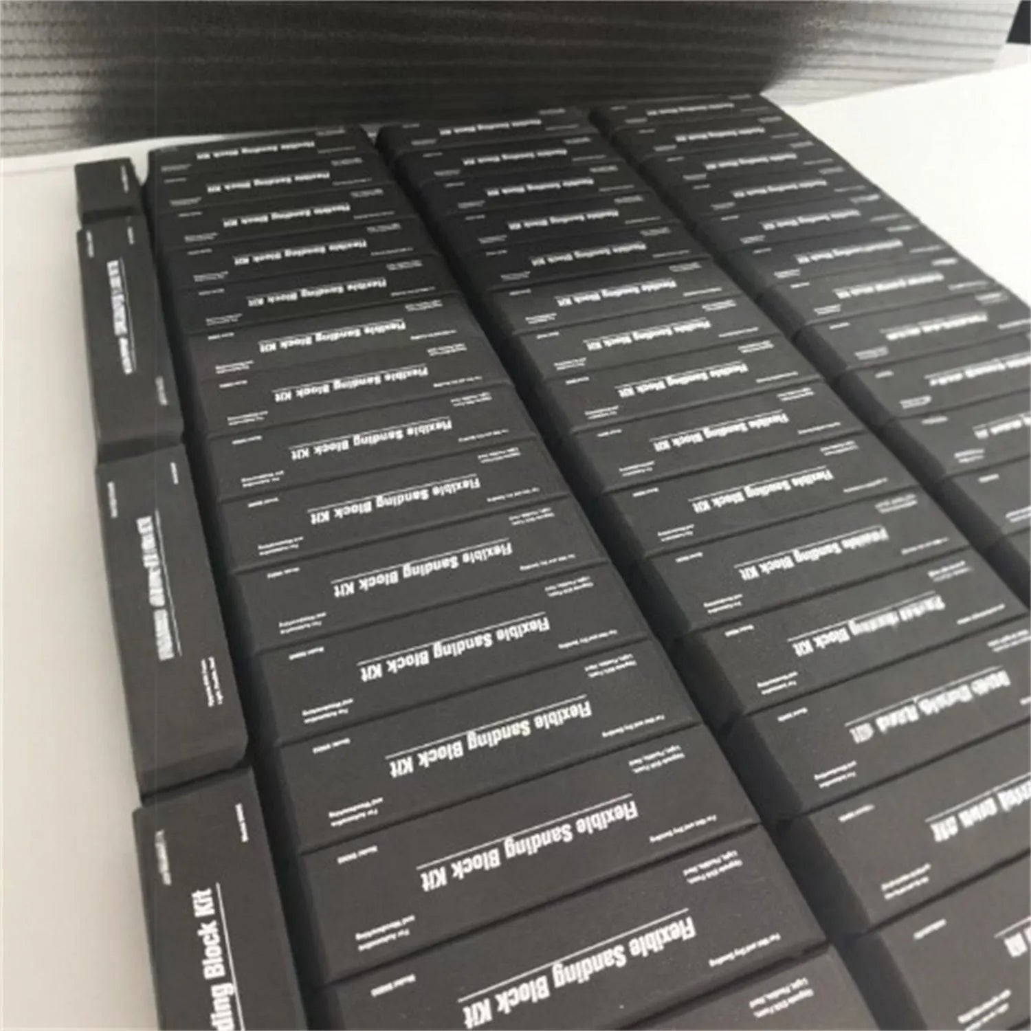 Seven black frosted building blocks with metal construction arranged as a set