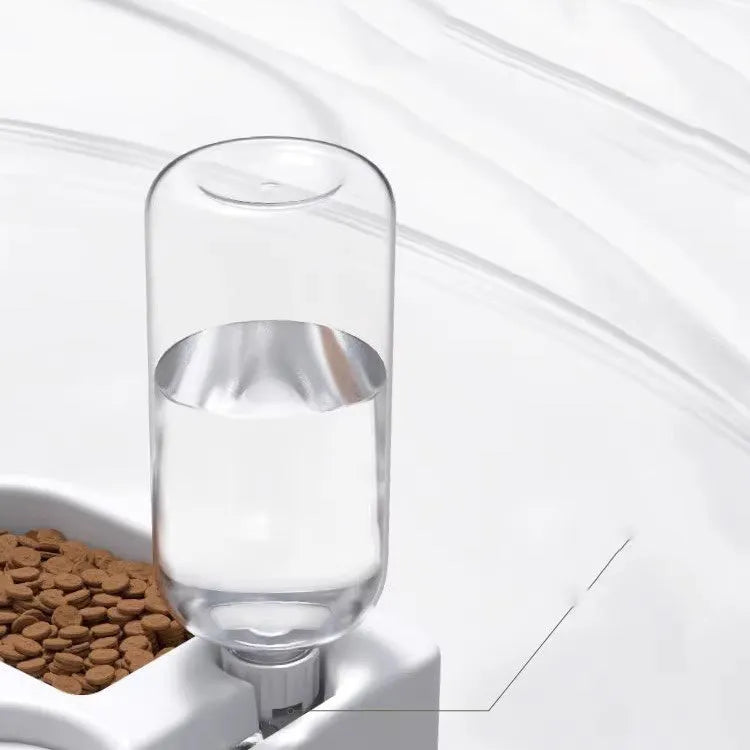 White plastic cat water fountain with filter on a floor next to a cat.