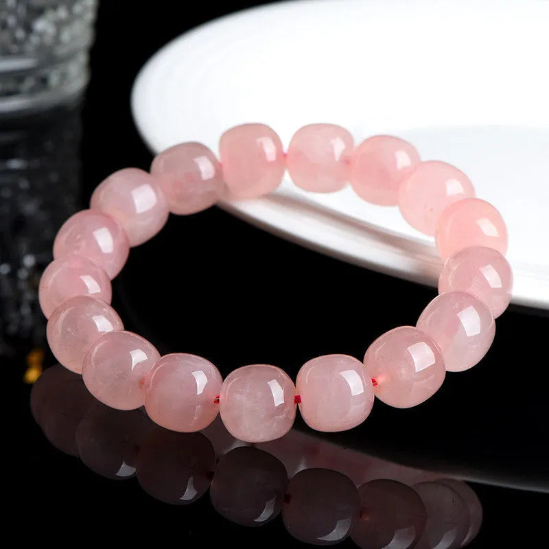 Pink natural crystal barrel bead bracelet with geometric shape on wrist