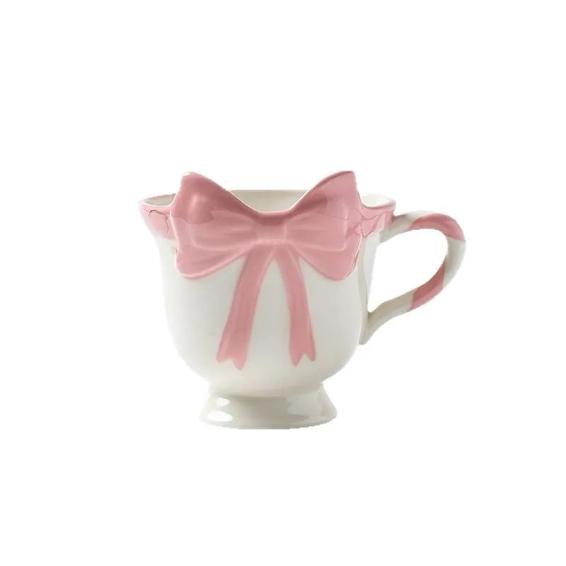 Ceramic mug with a decorative heart bow design in black pink or white powder colour.