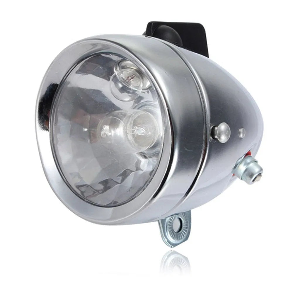 Silver bicycle dynamo generator light kit mounted on a bike fork, with wires for headlight and tail light connections.
