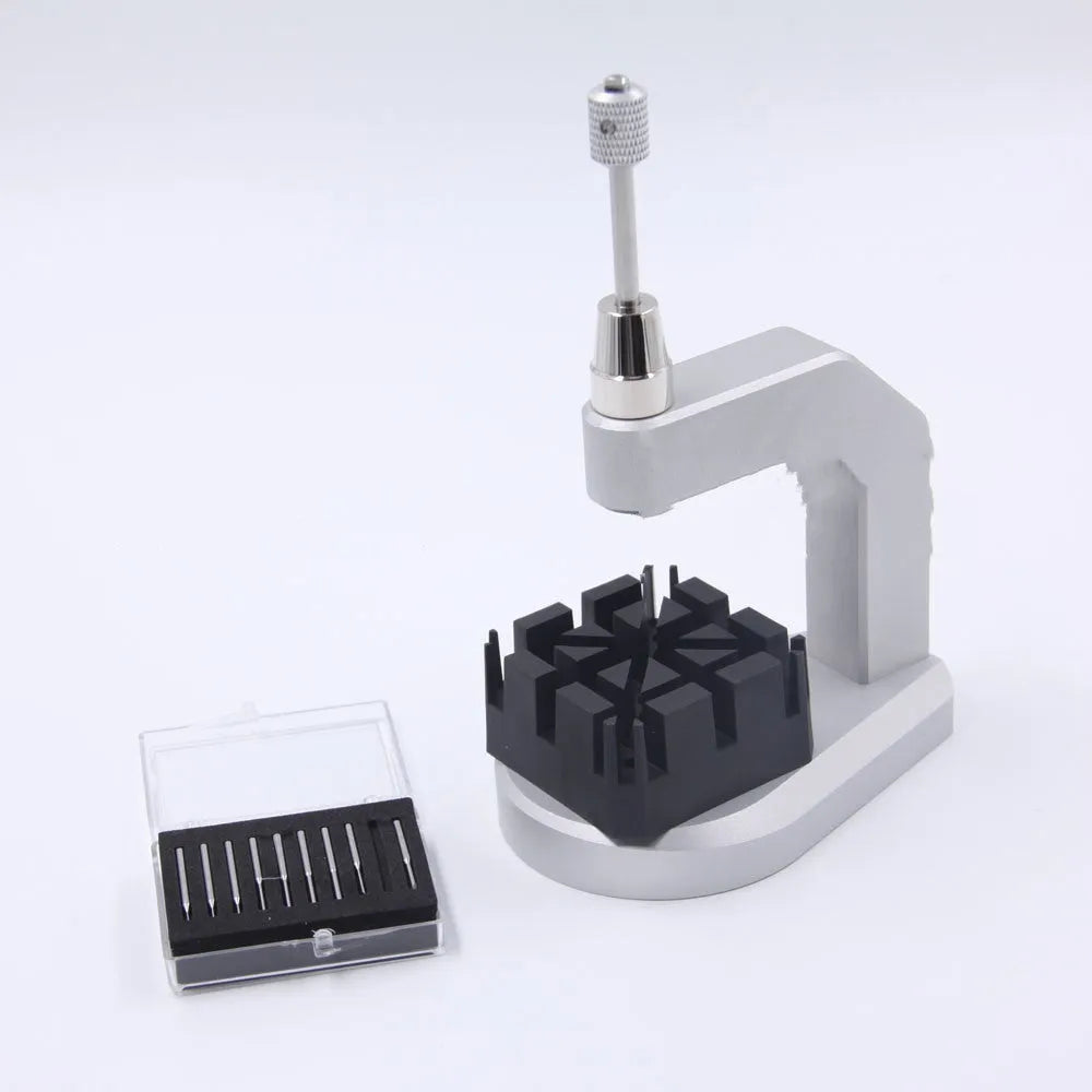 Silver multi-purpose press strap removal tool with a pointed blade for watch and jewellery repair.