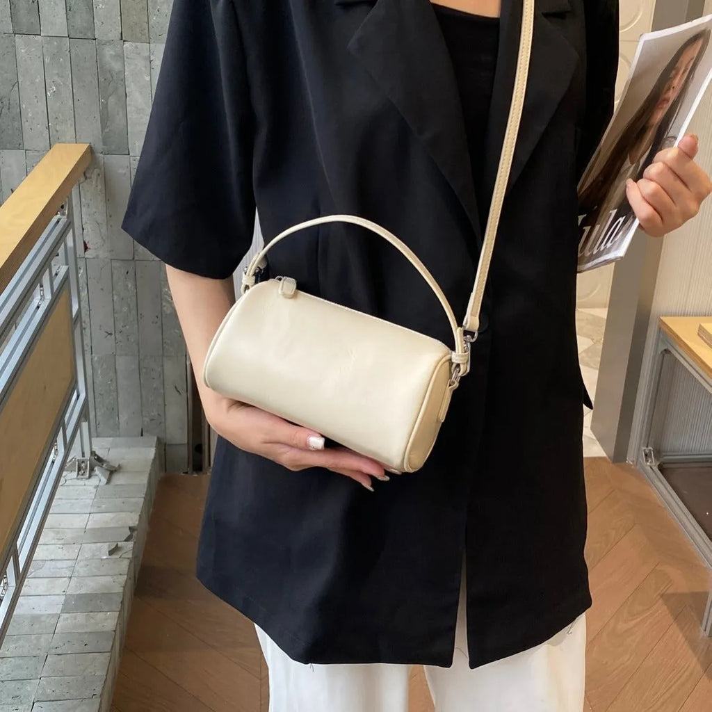 Cylindrical leather crossbody phone bag in vegetable tanned genuine leather with sewing thread detailing