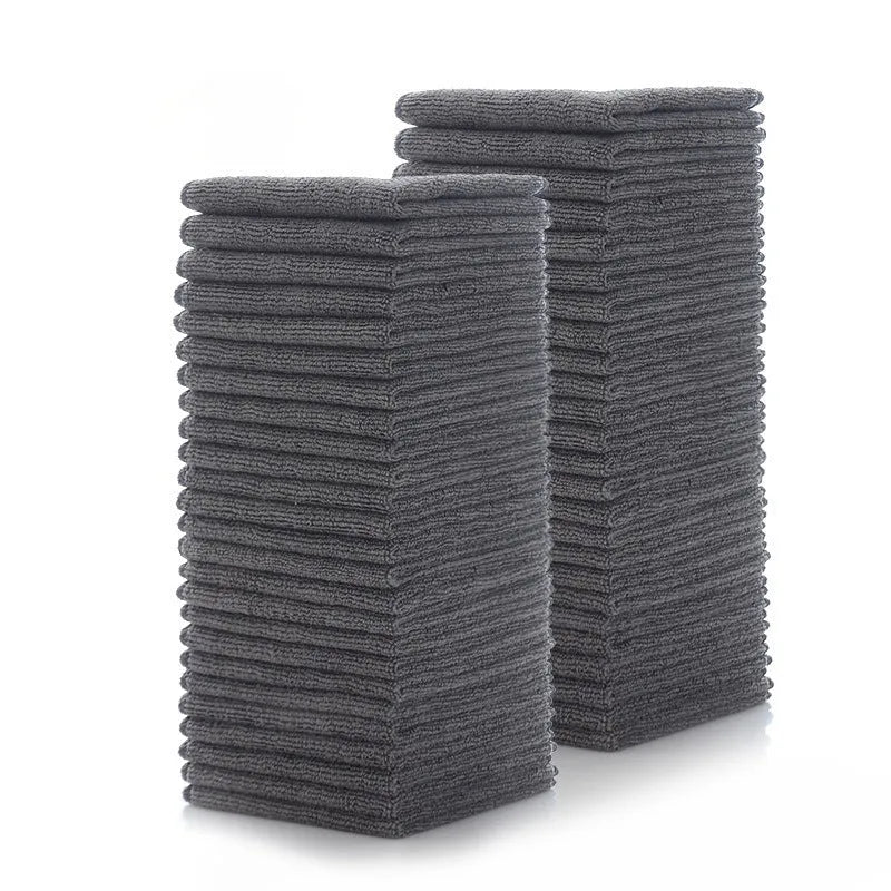 Grey square microfiber kitchen cleaning cloth for oil and grease removal on pots.