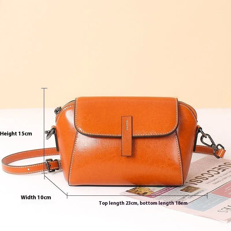 Women's brown oil wax cowhide leather messenger bag with cross-body strap and internal compartments