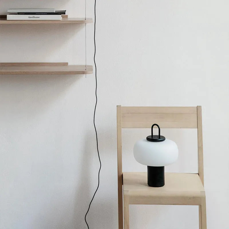 Minimalist Japanese-style glass bedside table lamp for a child's creative bedroom.